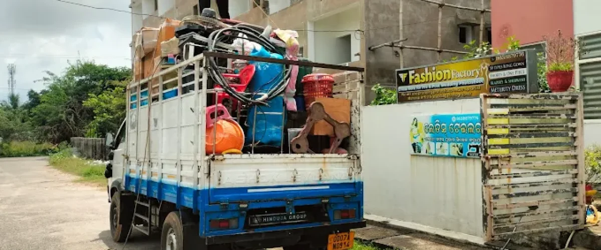 Loading household furniture into moving truck in Berhampur